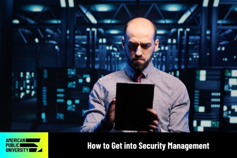 how-to-get-into-security-management security management professional looking at tablet